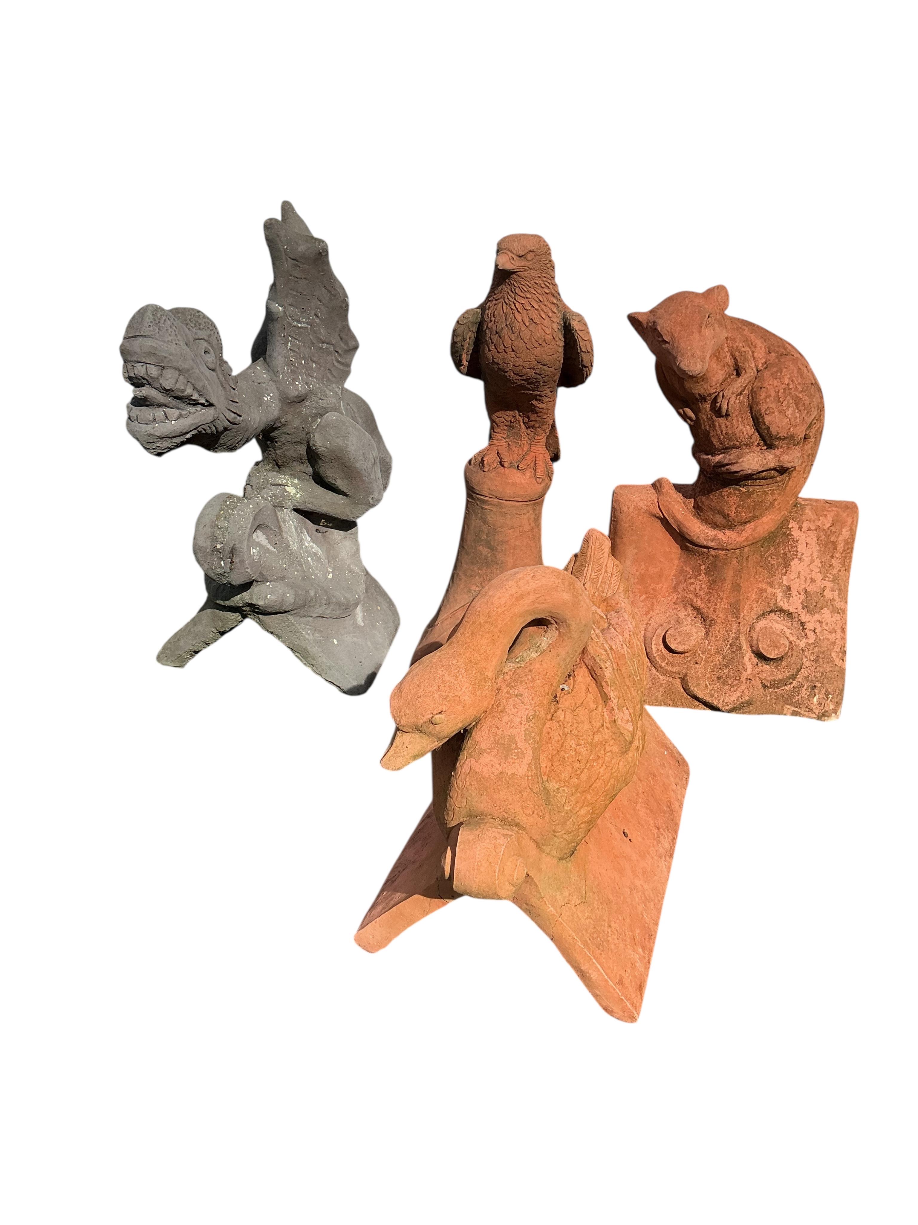 Four cast stone ridge tiles, largest height 56cm